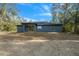 Rear view of house, showcasing a large backyard at 14 Guava Terrace Trce, Ocklawaha, FL 32179