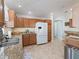 Kitchen with granite countertops, wood cabinets, and modern appliances at 1654 Summerchase Loop, The Villages, FL 32162