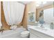 Clean bathroom with a shower/tub combo, white vanity, and tile flooring at 2185 Derringer Ave, The Villages, FL 32162