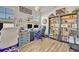 Home office with two desks, multiple monitors, and ample built-in shelving at 2298 Raven Ridge Rd, Minneola, FL 34715