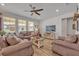 Spacious living room with neutral colored leather couches and a large TV at 2298 Raven Ridge Rd, Minneola, FL 34715