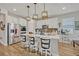 Modern kitchen with island, white cabinets, and stainless steel appliances at 2298 Raven Ridge Rd, Minneola, FL 34715