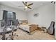 Bright bedroom with full-size bed, desk and window at 2298 Raven Ridge Rd, Minneola, FL 34715