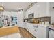 Modern kitchen with island, white cabinets, and stainless steel appliances at 2298 Raven Ridge Rd, Minneola, FL 34715