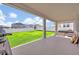 Covered patio with seating area and spacious backyard at 2298 Raven Ridge Rd, Minneola, FL 34715