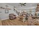 Open concept living room features brown leather sofas, coffee table and kitchen views at 2298 Raven Ridge Rd, Minneola, FL 34715