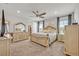 Main bedroom with large bed, dresser, and plenty of natural light at 2298 Raven Ridge Rd, Minneola, FL 34715