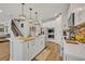 Modern kitchen with island, white cabinets, and stainless steel appliances at 2298 Raven Ridge Rd, Minneola, FL 34715