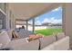 Relaxing covered patio with seating and a view of the backyard at 2298 Raven Ridge Rd, Minneola, FL 34715