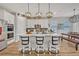 Modern kitchen with island, white cabinets, and stainless steel appliances at 2298 Raven Ridge Rd, Minneola, FL 34715