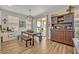 Bright dining room features rustic farmhouse table with bench seating, and a large hutch at 2298 Raven Ridge Rd, Minneola, FL 34715