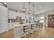 Modern kitchen with island, white cabinets, and stainless steel appliances at 2298 Raven Ridge Rd, Minneola, FL 34715
