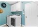 Laundry room with white cabinets and modern washer/dryer set at 3509 Indian Trl, Eustis, FL 32726