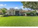 Single-story home with landscaped lawn and teal door at 3509 Indian Trl, Eustis, FL 32726