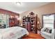 Relaxing main bedroom with a comfortable bed and wood floors at 3721 Plantation Blvd, Leesburg, FL 34748