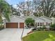 Attractive single-Gathering home with three-car garage and lush landscaping at 3721 Plantation Blvd, Leesburg, FL 34748