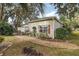Small, cozy backyard with a patio and lush landscaping at 3721 Plantation Blvd, Leesburg, FL 34748