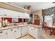 Spacious kitchen with granite countertops, white cabinets, and breakfast nook at 3721 Plantation Blvd, Leesburg, FL 34748