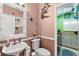 Small bathroom with a toilet and sink, near the laundry room at 3721 Plantation Blvd, Leesburg, FL 34748