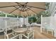 Private patio with seating area, partially enclosed by lattice fencing at 3721 Plantation Blvd, Leesburg, FL 34748