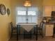 Cozy kitchen breakfast nook with a small table and two chairs, perfect for a quick meal at 956 Chula Ct, The Villages, FL 32159