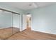 Bedroom with mirrored closet and access to bathroom at 1112 Paradise Dr, The Villages, FL 32159