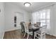 Dining area with wood floors and a rustic table, seating four at 1150 Angela Ridge Ct, Kissimmee, FL 34747