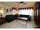 Living room with black leather sofas, a coffee table, and a wooden cabinet at 13162 Se 93Rd Terrace Rd, Summerfield, FL 34491