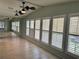 Sunlit living area with multiple windows and wood-look floors at 1617 Hilton Head Blvd, Lady Lake, FL 32159