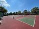 Red and green tennis courts in a community park at 2306 Edmonton Ct, Clermont, FL 34711