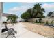 Landscaped backyard with patio, seating area, and tropical plants at 2339 Nehaul Ter, The Villages, FL 32162