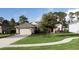 Single-story house with stone accents and a two-car garage at 34932 Golden Tree Dr, Leesburg, FL 34788
