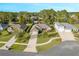 Aerial view of a residential neighborhood with houses and lush green landscaping at 34932 Golden Tree Dr, Leesburg, FL 34788