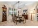 Bright dining room with a wooden table and chairs, and a beautiful chandelier at 34932 Golden Tree Dr, Leesburg, FL 34788