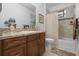 Bathroom with a vanity, bathtub, and tiled shower surround at 34932 Golden Tree Dr, Leesburg, FL 34788