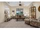 Living room with a sofa, armchairs, and a large window at 34932 Golden Tree Dr, Leesburg, FL 34788