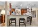 Kitchen features a breakfast bar with seating, stainless steel appliances, and ample cabinetry at 34932 Golden Tree Dr, Leesburg, FL 34788