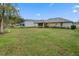 Spacious backyard with a view of home and neighboring property at 34932 Golden Tree Dr, Leesburg, FL 34788