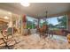 Relaxing screened porch with patio furniture and backyard views at 34932 Golden Tree Dr, Leesburg, FL 34788