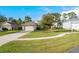 Single-story home with a two-car garage and landscaped front yard at 34932 Golden Tree Dr, Leesburg, FL 34788