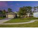 Single-story home with a two-car garage and landscaped front yard at 34932 Golden Tree Dr, Leesburg, FL 34788