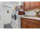 Bright laundry room with washer, dryer, and ample cabinetry at 34932 Golden Tree Dr, Leesburg, FL 34788