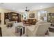 Relaxing living room with ample seating and a large TV at 34932 Golden Tree Dr, Leesburg, FL 34788