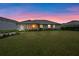Large backyard with view of home at sunset at 34932 Golden Tree Dr, Leesburg, FL 34788