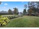 Landscaped backyard with a walkway and shed at 34932 Golden Tree Dr, Leesburg, FL 34788