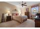 Bedroom with a queen bed, nightstands, and a wooden dresser at 34932 Golden Tree Dr, Leesburg, FL 34788