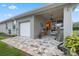 Spacious paved patio with grill and access to garage at 34932 Golden Tree Dr, Leesburg, FL 34788