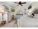 Main bedroom features a large bed, dresser, and plenty of natural light at 34932 Golden Tree Dr, Leesburg, FL 34788