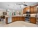 Modern kitchen with stainless steel appliances and wood cabinets at 34932 Golden Tree Dr, Leesburg, FL 34788