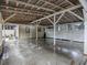 Open carport with concrete flooring and white wooden support beams at 351 W 10Th Ave, Mount Dora, FL 32757